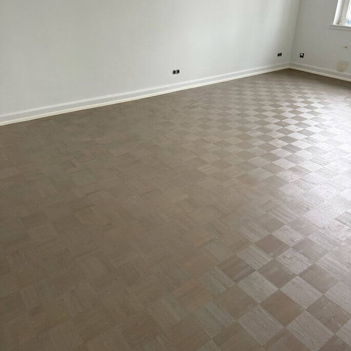 Abgenutztes Würfelparkett in einer Frankfurter Wohnung vor dem Schleifen
